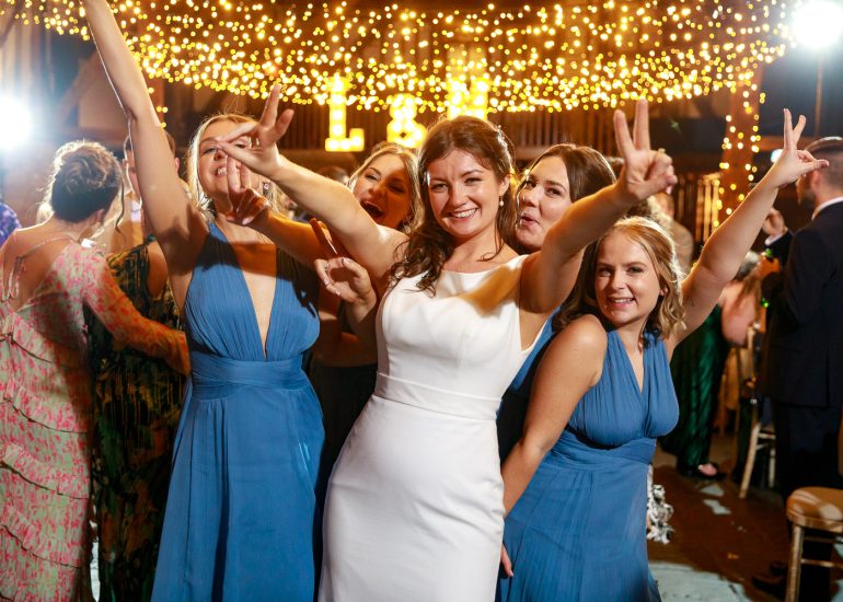 A group of bridesmaids dancing at a Cooling Castle wedding reception.